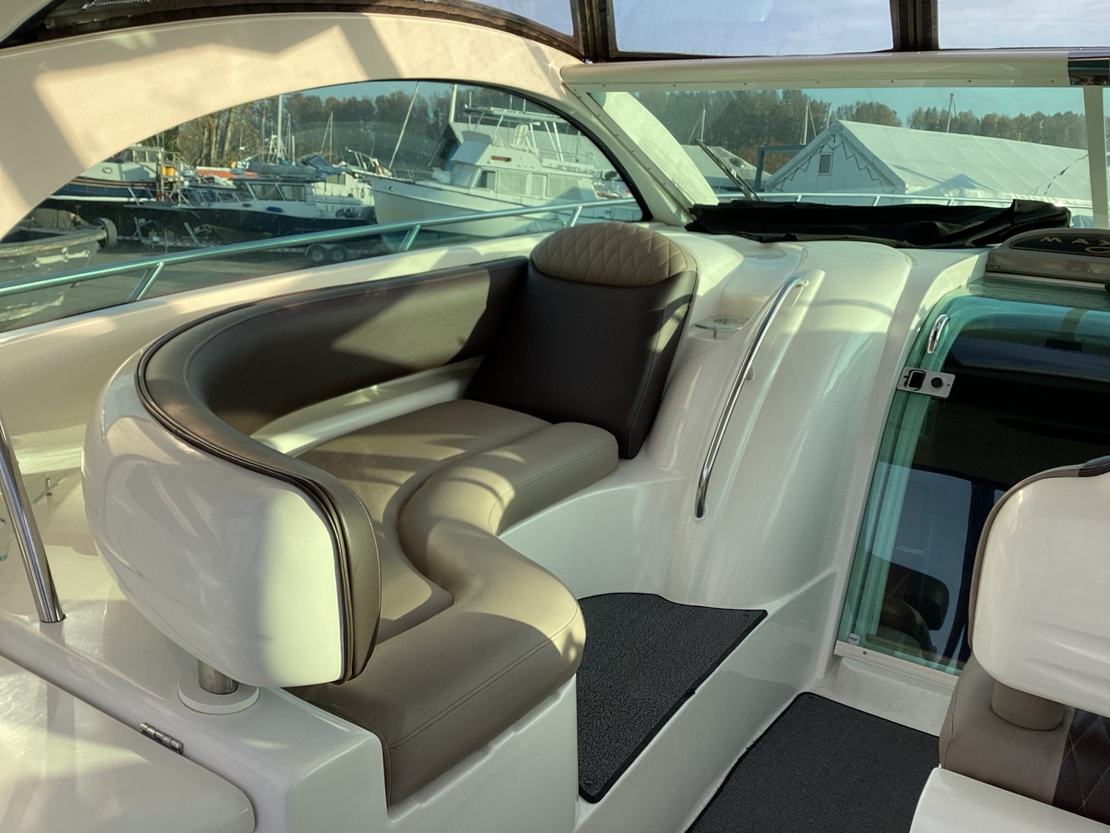 Boat bow seating in fresh marine vinyl upholstery, photographed at a marina