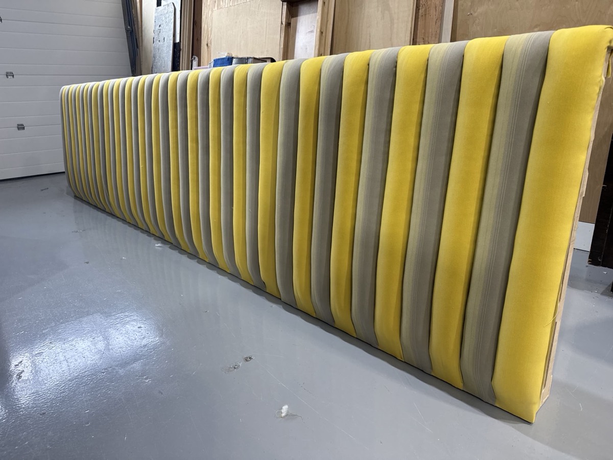 Long yellow and grey striped fluted banquette back panel finished in the workshop